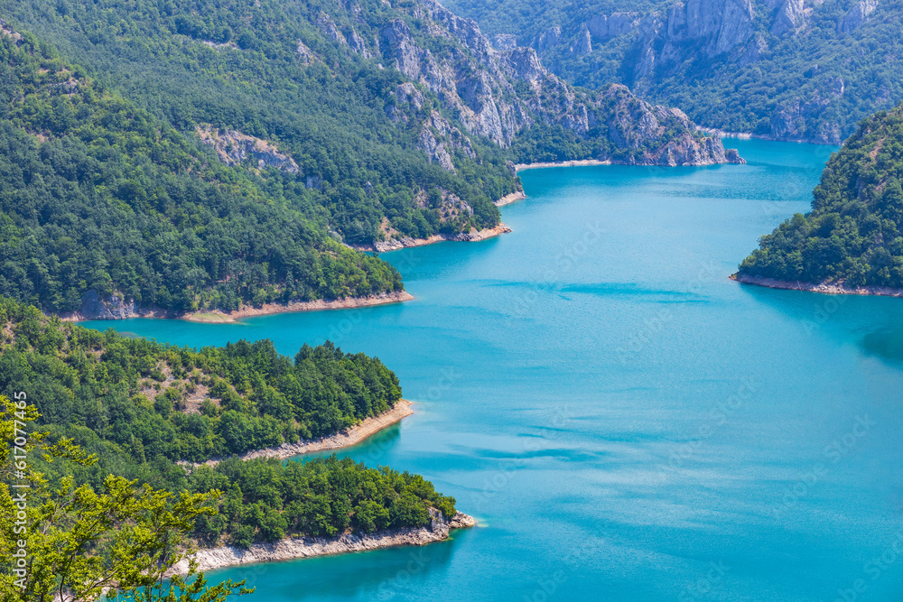 Aerial view of Piva lake or Pivsko Jezero between mountains covered with green trees