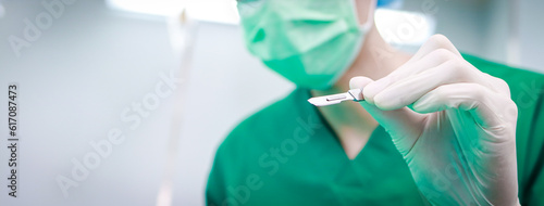 Professional surgeon holding a scalpel operating in a hospital operating room. doctor concept. copy space