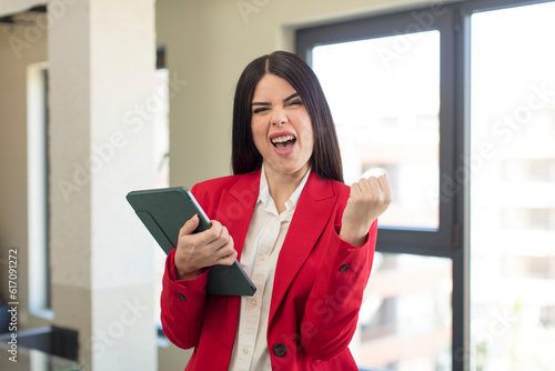 pretty young woman looking angry, annoyed and frustrated. touch screen pad concept