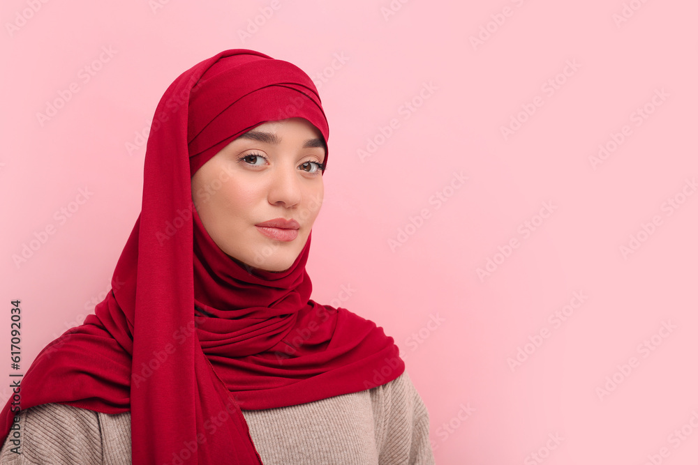 Portrait of Muslim woman in hijab on pink background, space for text Portrait of Muslim woman in hijab on pink background, space for text