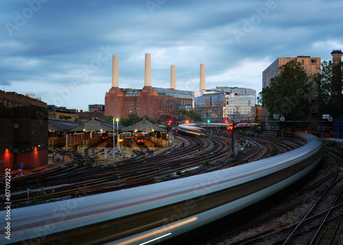 Battersea Power Station at dusk with train and moody sky