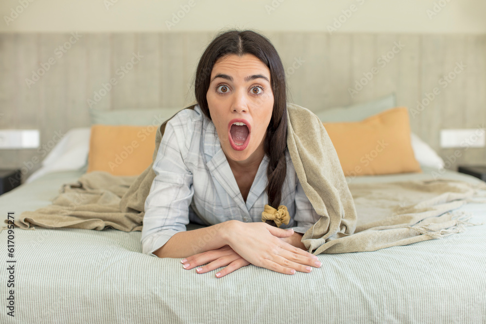 Obraz premium pretty young model feeling extremely shocked and surprised. rest and nightwear concept