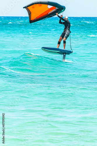   Front view, far distance of, young, male wind surfing, on  a wind canape power board, on Mediterranean sea, off Bandle, France photo