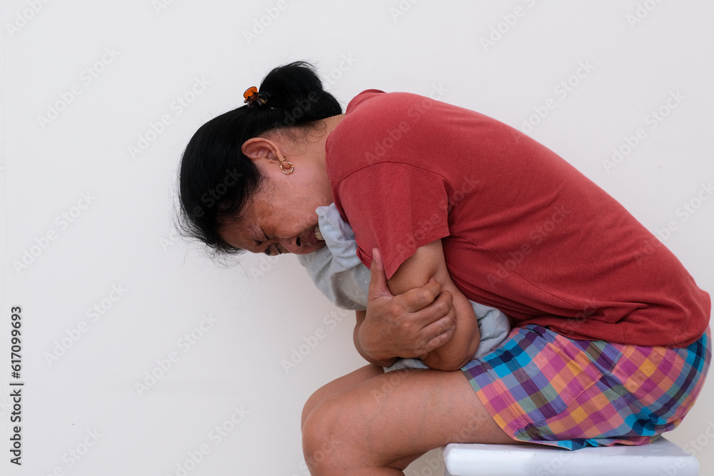 Closeup shot of a woman in casual clothes hugging pillow looking sick Closeup shot of a woman in casual clothes hugging pillow looking sick