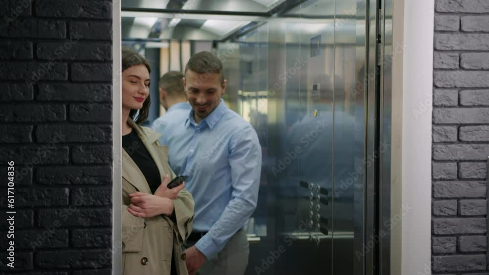 A successful businessman enters the elevator where his colleague is standing A successful businessman enters the elevator where his colleague is standing
