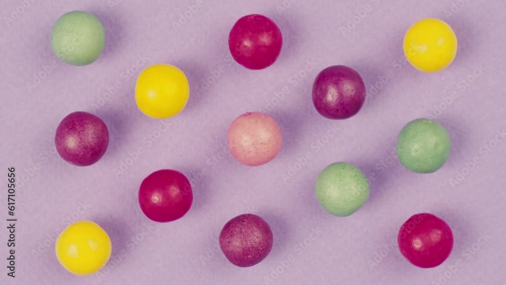 Colorful dragee candies on purple background. Summer bright texture studio shot for store, supermarket, close up top view, zoom. Children sweets made of sugar, mix of lollipops, bonbons. Colorful dragee candies on purple background. Summer bright texture studio shot for store, supermarket, close up top view, zoom. Children sweets made of sugar, mix of lollipops, bonbons.