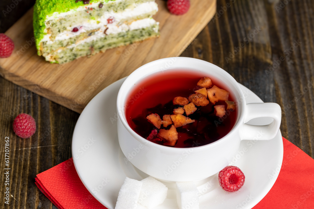 Red raspberry tea with pieces of fruit and berries Red raspberry tea with pieces of fruit and berries