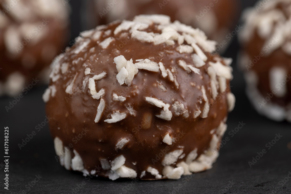 Chocolate candies in the form of balls with milk coconut