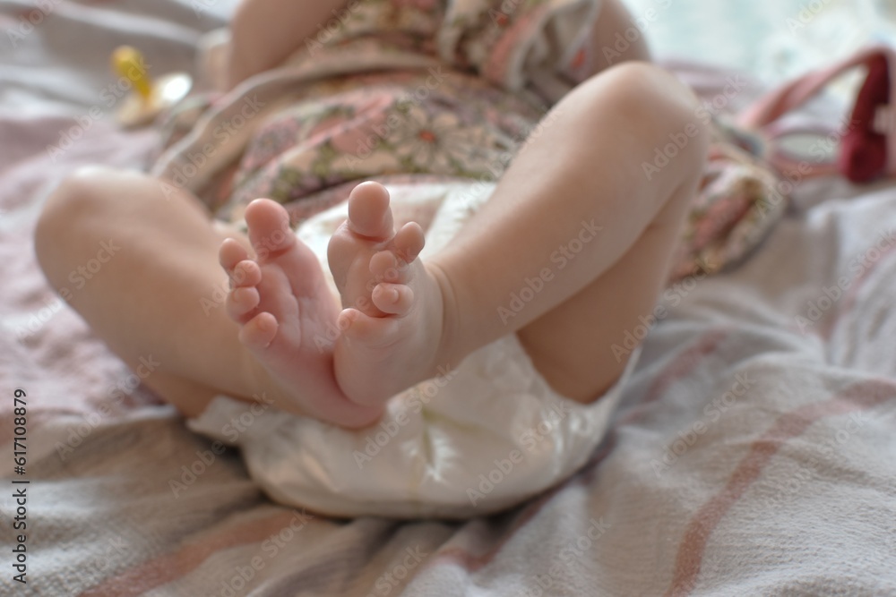a small child in diapers lies on the bed a small child in diapers lies on the bed