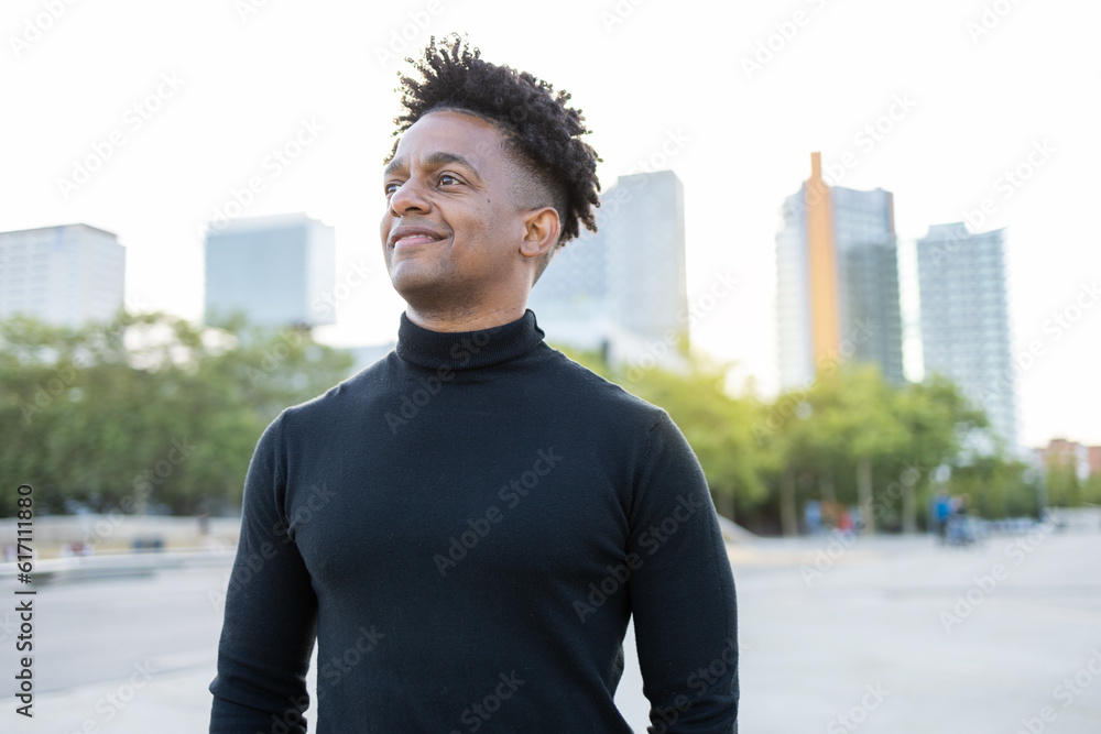 Smiling ethnic man standing on street Smiling ethnic man standing on street