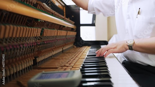 The scene of professional services piano tuning piano keys, skilled profession, musician maintenance.