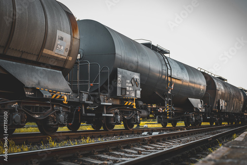 Transportation tank cars with oil during sunset. Railway containers. Freight railway wagons. Railway tank.