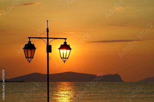 Street Lights at Sunrise against islands of the Aegean Sea