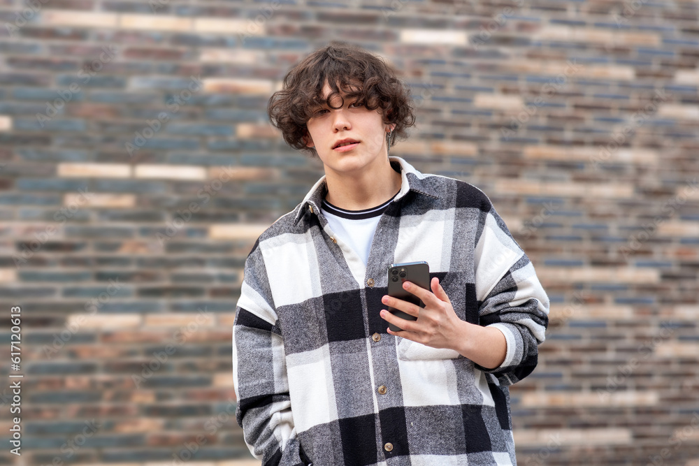 Fototapeta premium portrait of a young man against a brick wall