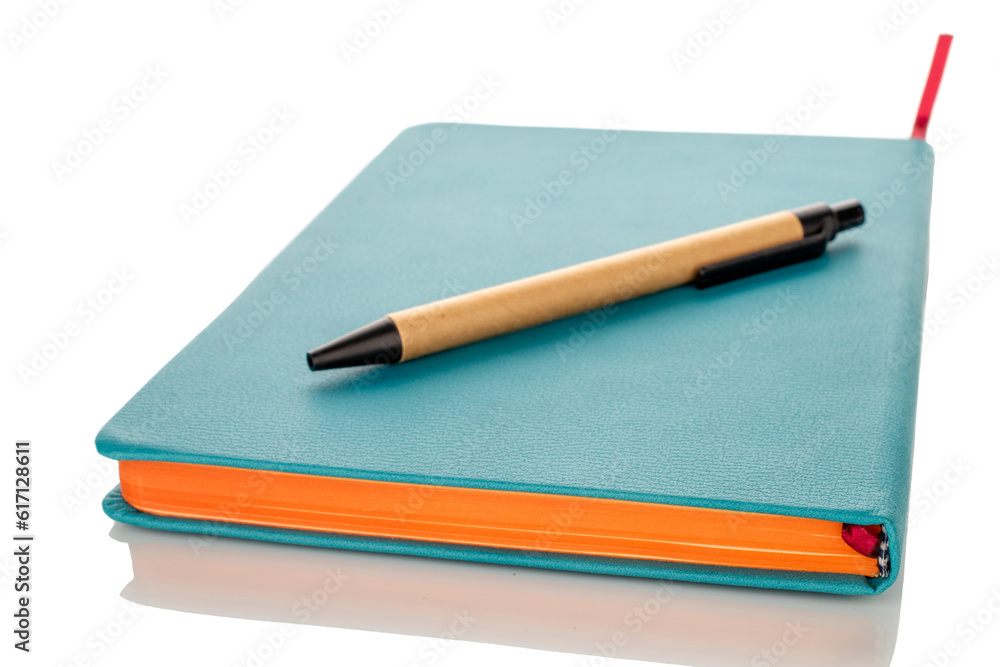 One notebook with pen, macro, isolated on white background. One notebook with pen, macro, isolated on white background.