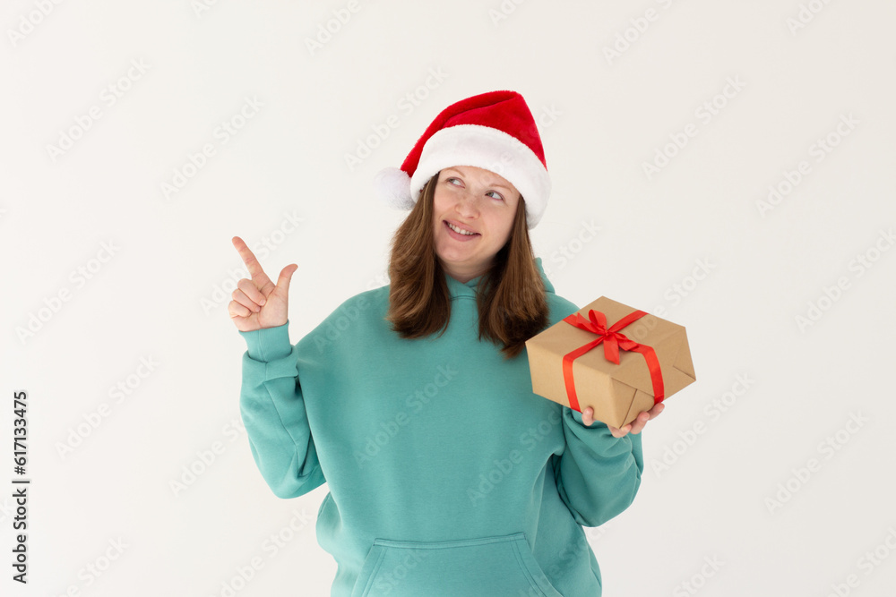 Photo of sweet cute pregnant woman wear green hoodie holding xmas present pointing empty space isolated white color background Photo of sweet cute pregnant woman wear green hoodie holding xmas present pointing empty space isolated white color background