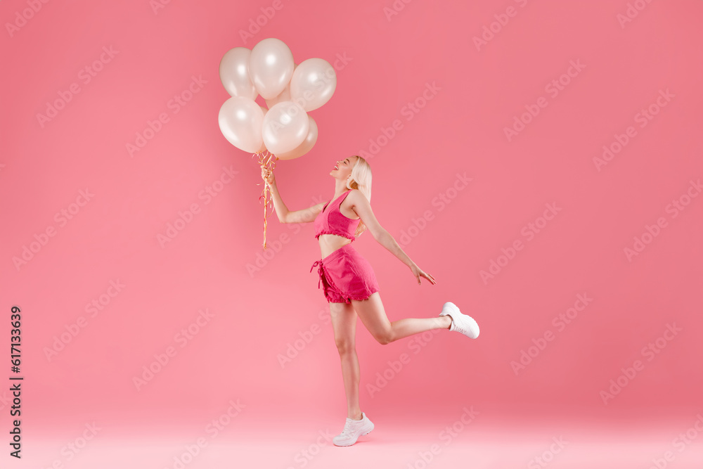 Full length shot of romantic lovely blonde lady holding baloons want to fly up, posing isolated on pink color background Full length shot of romantic lovely blonde lady holding baloons want to fly up, posing isolated on pink color background