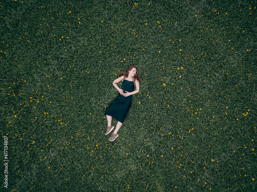 girl lies in a field of daisies
