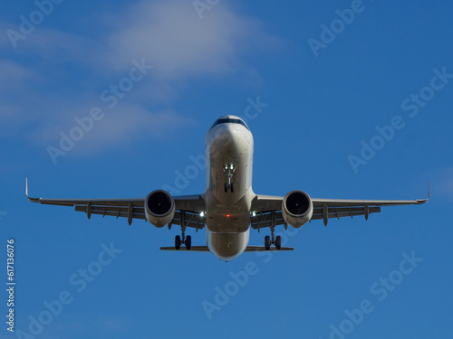 White passenger airplane flying in the sky clouds in the background -