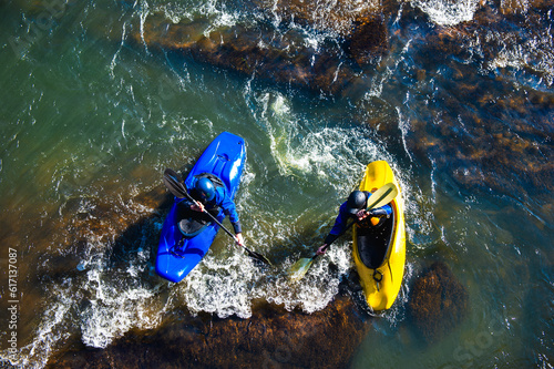 A father and son paddle whitewater on the Chattahoochee River in Atlanta, Georgia, overhead shot photo
