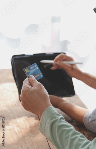 Close up mature man holding plastic credit card, senior couple family paying online, using laptop, satisfied older customers making secure internet payment, shopping, browsing banking service