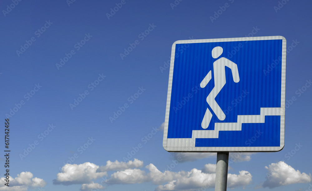 Underpass sign pointer on the background of the sky with clouds Underpass sign pointer on the background of the sky with clouds