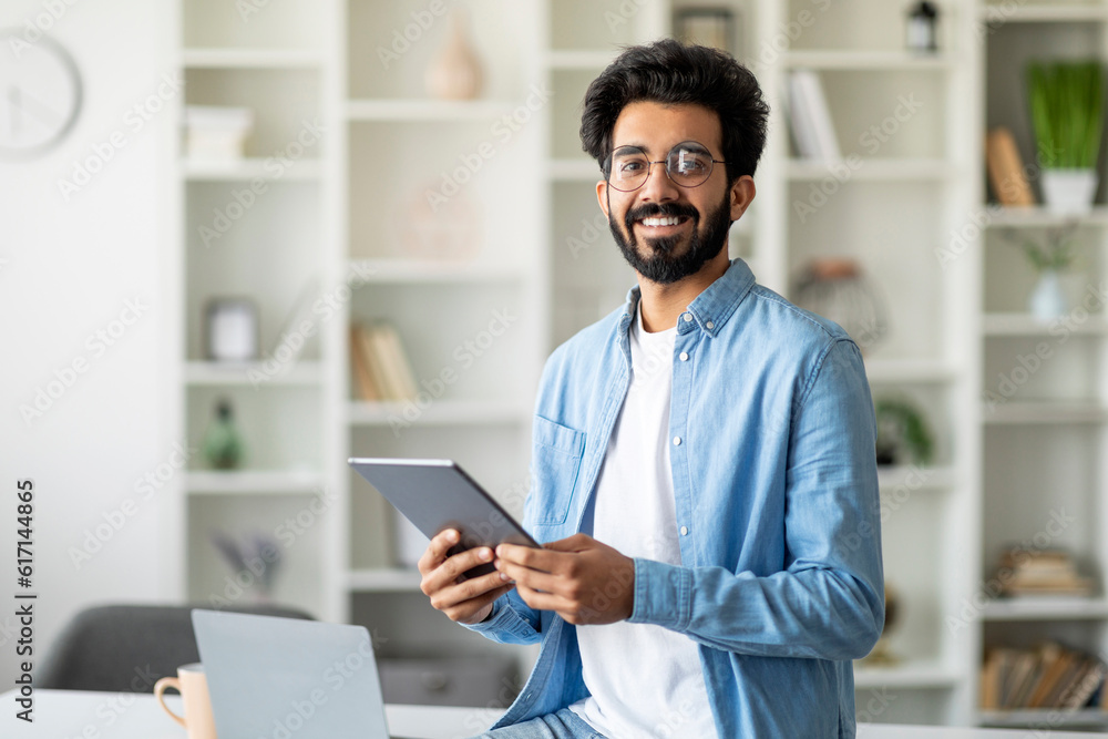 Portrait Of Handsome Indian Male Freelancer With Digital Tablet In Hands Portrait Of Handsome Indian Male Freelancer With Digital Tablet In Hands