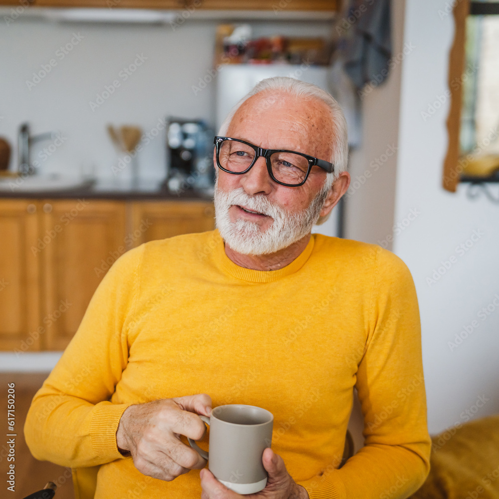 One senior man sit at home in the kitchen with cup of tea or coffee One senior man sit at home in the kitchen with cup of tea or coffee