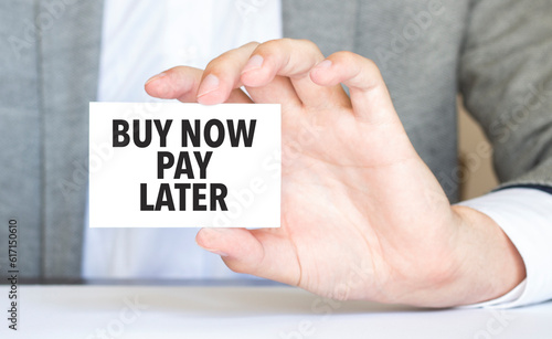 Businessman holding a card with text buy now pay later