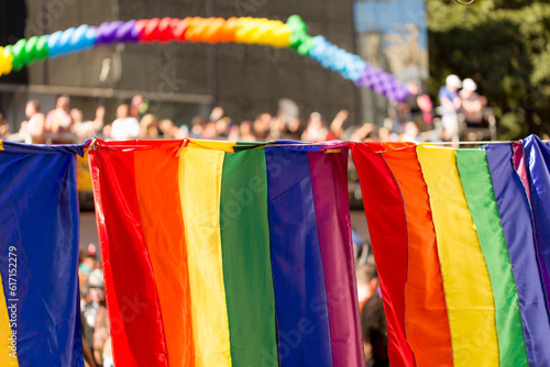 Bandeira símbolo do orgulho gay e publico ao fundo. 27ª edição, Parada do Orgulho LGBT+ de São Paulo, Brasil.  photo