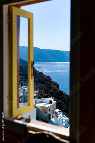 santorini house window view of the oia caldera and cycladic white houses aegean sea greece © GreeceYou