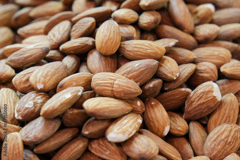 Close up many macro fresh almond dried nuts background wallpaper. Close up many macro fresh almond dried nuts background wallpaper.