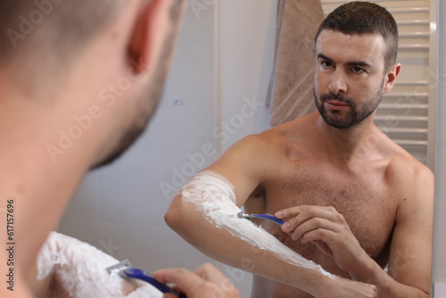 Man shaving his hairy forearms 