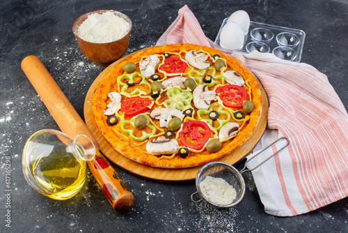 top view mushroom pizza with red tomatoes olives mushrooms all sliced inside with oil on the grey background pizza dough italian