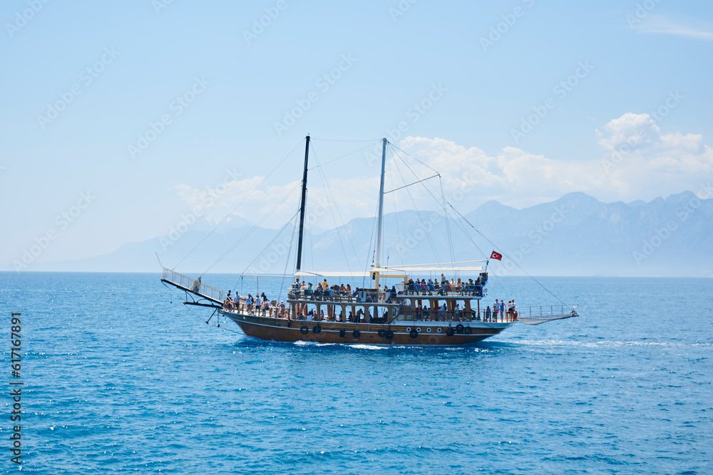 Sailing boat on the blue mediterranean sea, with a lot of tourists enjoying vacation Sailing boat on the blue mediterranean sea, with a lot of tourists enjoying vacation