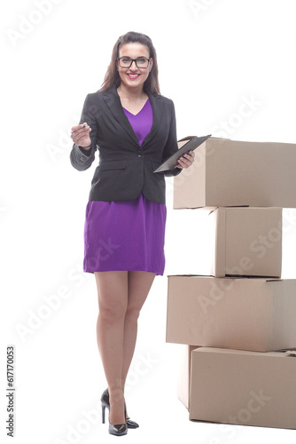 female courier with a signature tablet standing next to cardboard boxes © ASDF