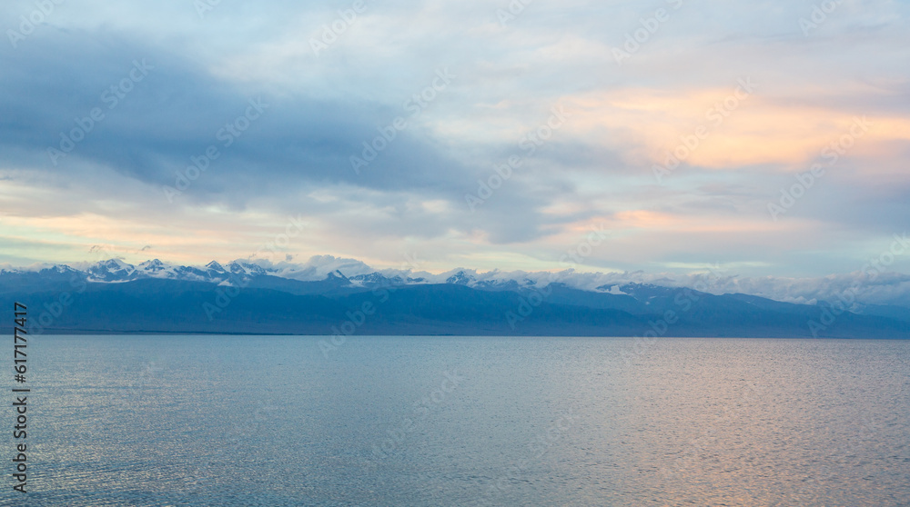 Landscape with Issik Kul lake and mountain in the evening. Clear water. background. Kyrgyzstan Landscape with Issik Kul lake and mountain in the evening. Clear water. background. Kyrgyzstan