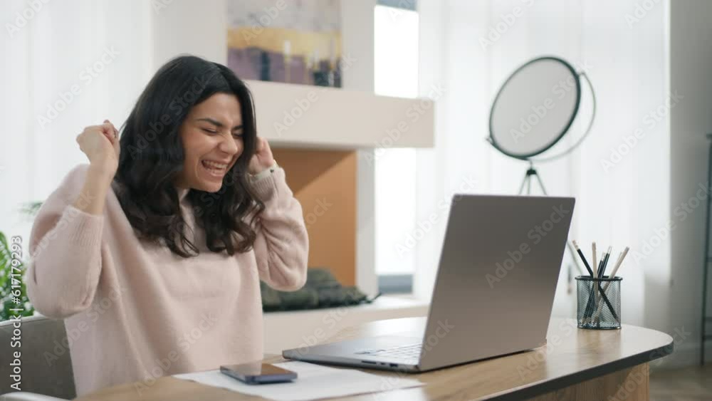 Excited young hispanic woman winner looks at laptop. Happy girl celebrates online success, working remotely at desktop at home. Euphoric latin lady gets new distance job opportunity reads good news 4K Excited young hispanic woman winner looks at laptop. Happy girl celebrates online success, working remotely at desktop at home. Euphoric latin lady gets new distance job opportunity reads good news 4K