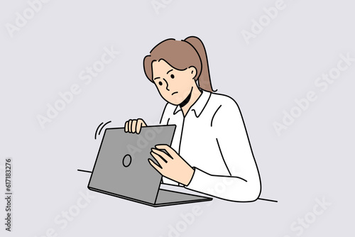 Woman is worried about privacy of data on internet and hides laptop screen while entering password. Taking care of security using internet and maintaining confidentiality to avoid information leakage