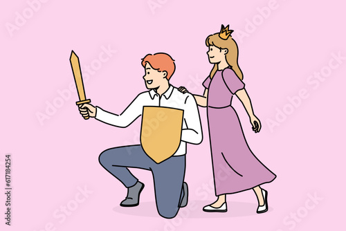 Princess girl near father with knight sword spend time together playing royal family from fairy tales. Hero protect princess from enemies saving little daughter for fatherhood concept