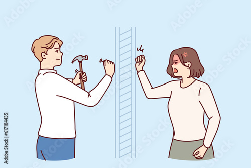 Angry woman knocks on wall swearing at neighbor is doing repairs in apartment and using hammer. Nervous girl quarreling with neighbor hammering nails because of noise caused by renovation