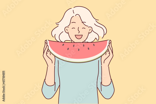 Teenage girl eats watermelon enjoying sweet taste of fruit that quenches thirst in summer weather