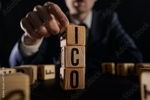letters of the alphabet of ICO on wooden cubes, ICO - short for initial coin offering photo