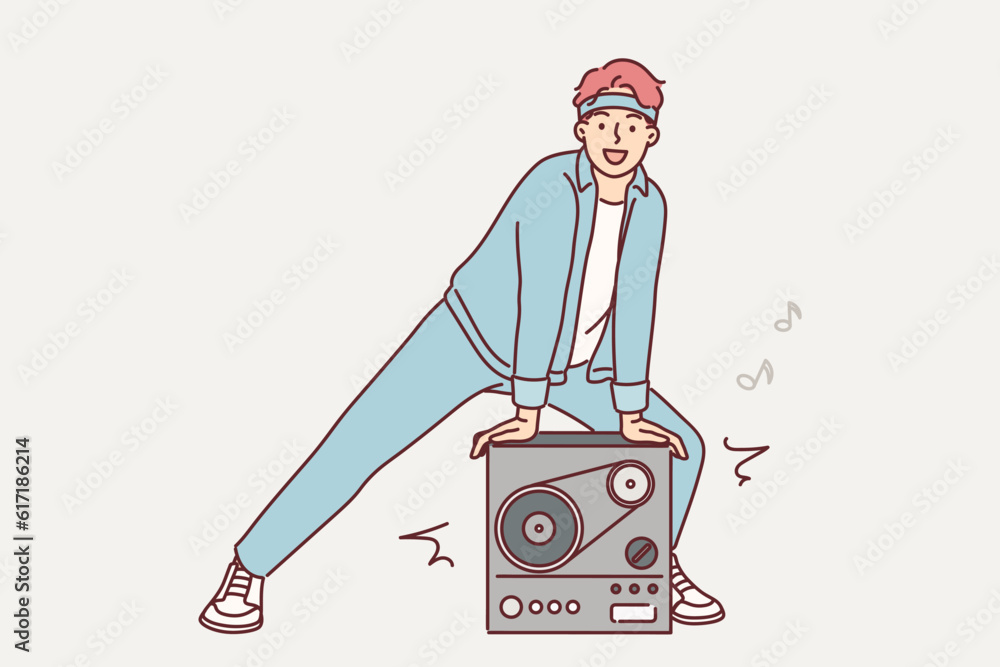 Man stands near retro tape recorder for playing music from tape and invites to party in style 90s