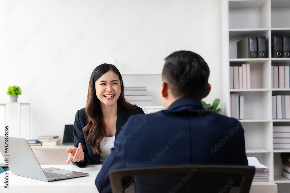 Smart and professional male manager working with his female assistant. check financial reports Analyze financial data with graph papers and laptop with desk. Smart and professional male manager working with his female assistant. check financial reports Analyze financial data with graph papers and laptop with desk.