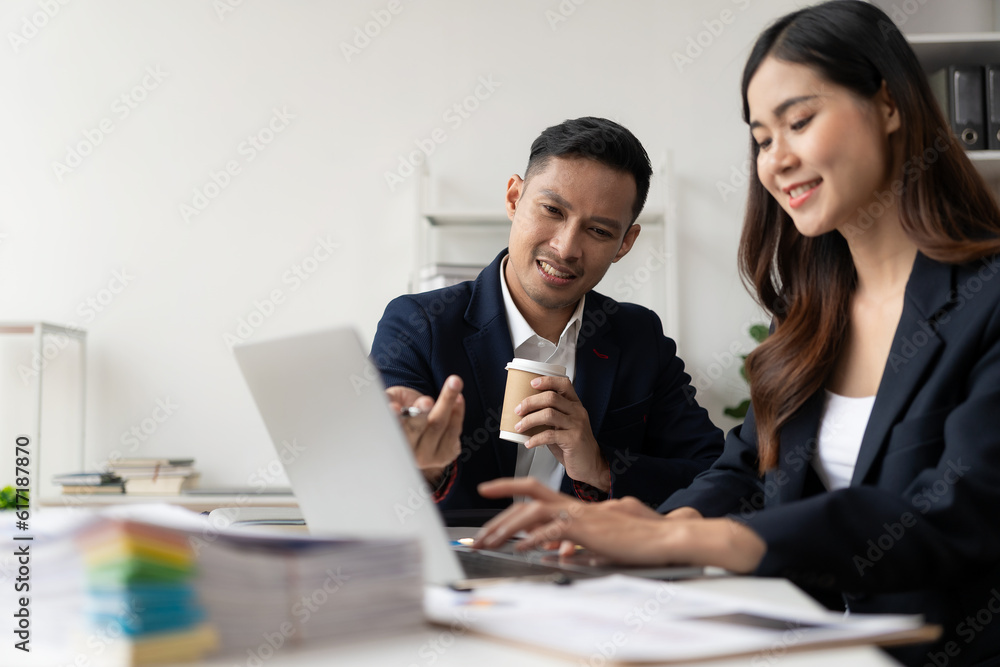 Smart and professional male manager working with his female assistant. check financial reports Analyze financial data with graph papers and laptop with desk. Smart and professional male manager working with his female assistant. check financial reports Analyze financial data with graph papers and laptop with desk.