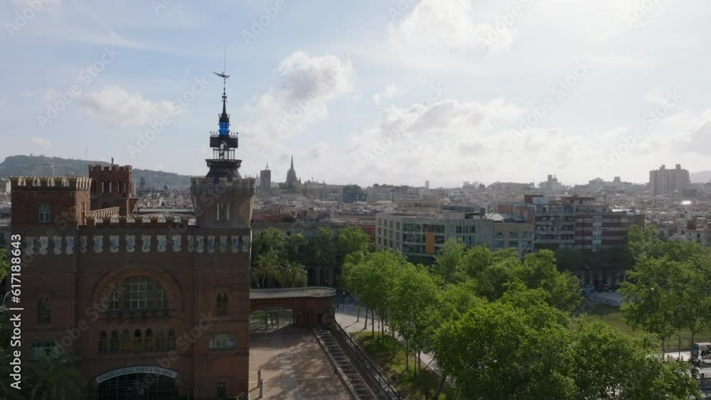 Forwards fly around historic Castell dels Tres Dragons. View of cityscape against sunshine. Barcelona, Spain Forwards fly around historic Castell dels Tres Dragons. View of cityscape against sunshine. Barcelona, Spain