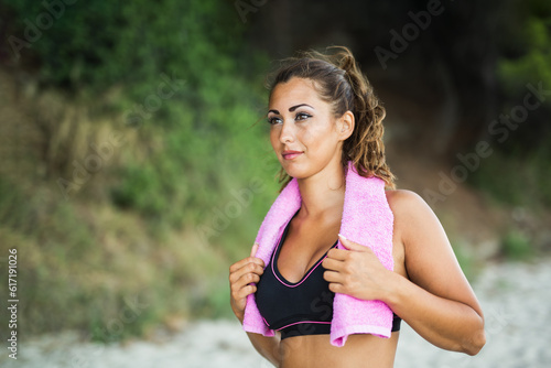 Woman Resting During Outdoors Training On The Beach