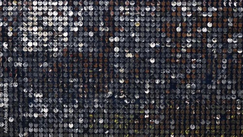 Silver mirror sequins sparkle and move in the wind, dynamic sparkling background