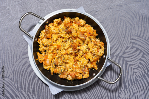 Traditional Portuguese snack of scrambled eggs cooked with flavorful farinheira sausage, sizzling in a frying pan photo
